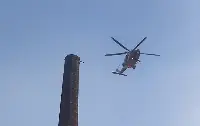 a man who has been stranded hanging from the top of an industrial chimney over 90 meters in North West England to Carlisle, in the county of Cumbria.