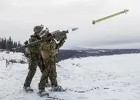 Two military personnel firing an FIM-92 Stinger anti-aircraft missile