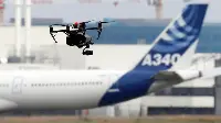 Drone during flight and an Airbus A-340 aircraft on background