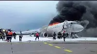 SSJ-100 aircraft of Aeroflot on the runway of the Moscow-Sheremetyevo airport on May 5, 2019: firemen try to put the flames under control