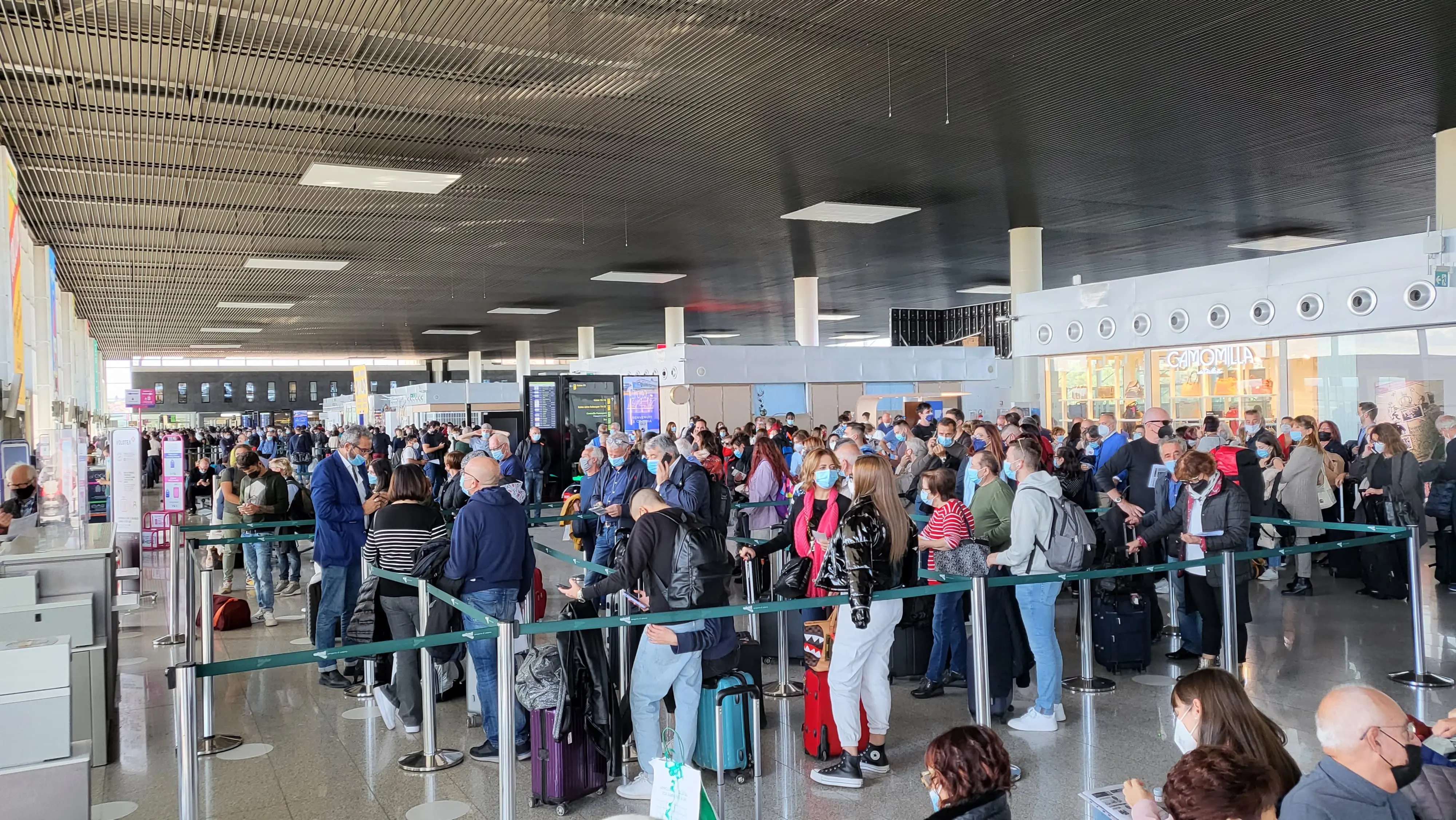 Passengers waiting in line at the departure area of Catania-Fontanarossa "Vincenzo Bellini" airport